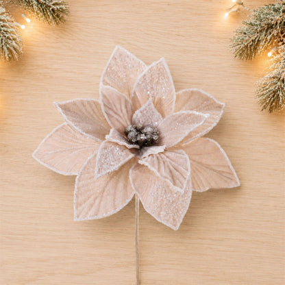 Artificial velvet poinsettia flower stem with glitter edges and dark beaded center, top view
