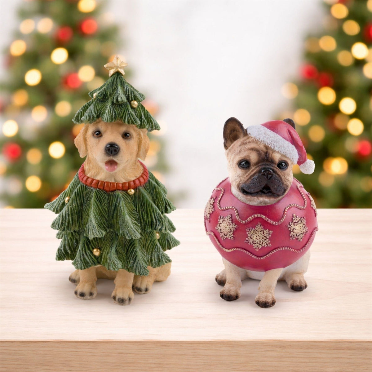 Two festive dog figurines dressed as a Christmas tree and holiday ornament with Santa hat