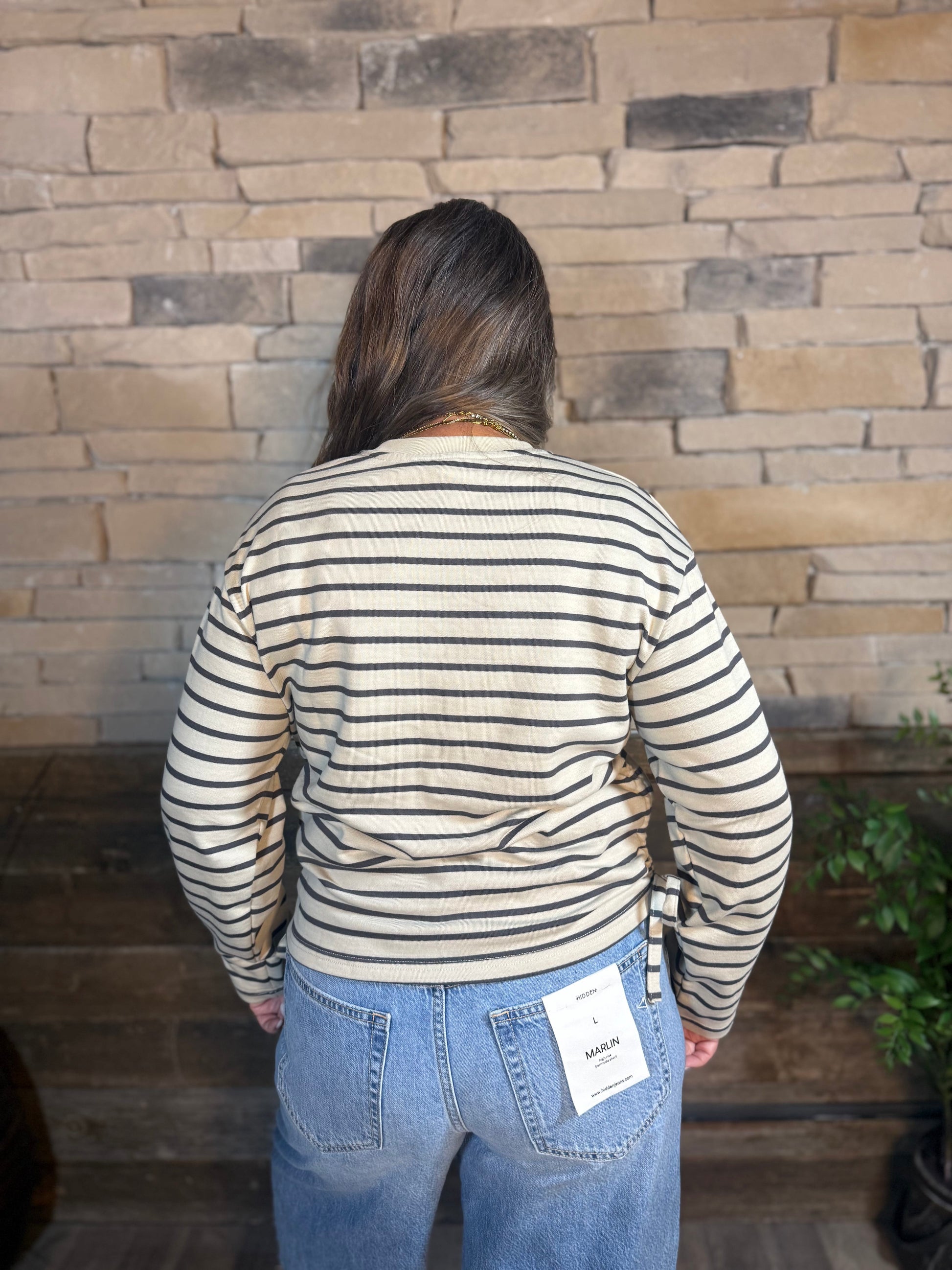 Cream and navy striped long sleeve crewneck sweatshirt with side drawstring detail
