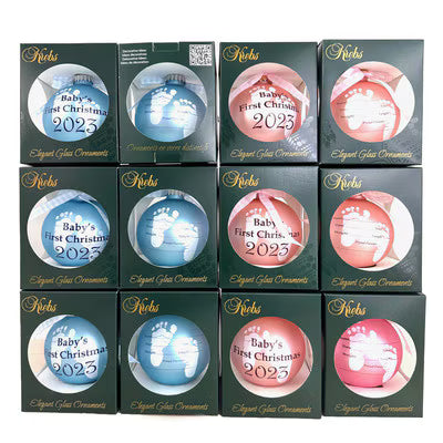 Twelve boxed Krebs Baby's First Christmas 2023 glass ornaments in blue and pink