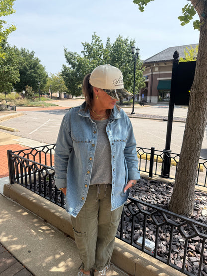 Light wash denim button-up shirt jacket with snap closures and chest pockets