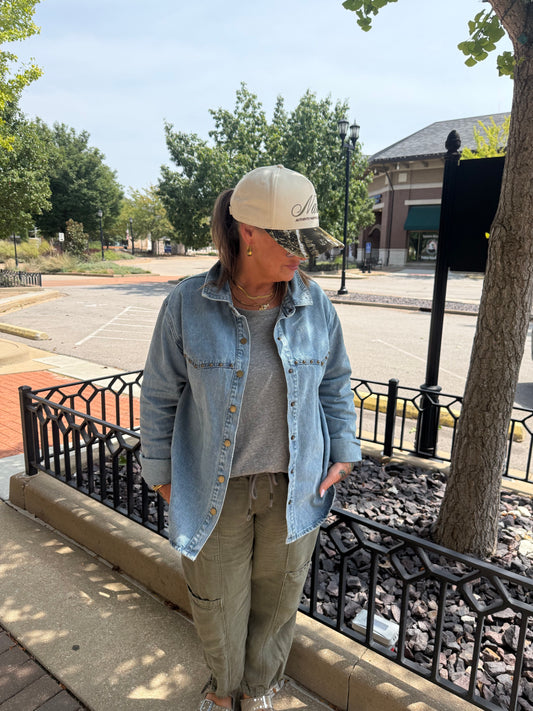Light wash denim button-up shirt jacket with snap closures and chest pockets