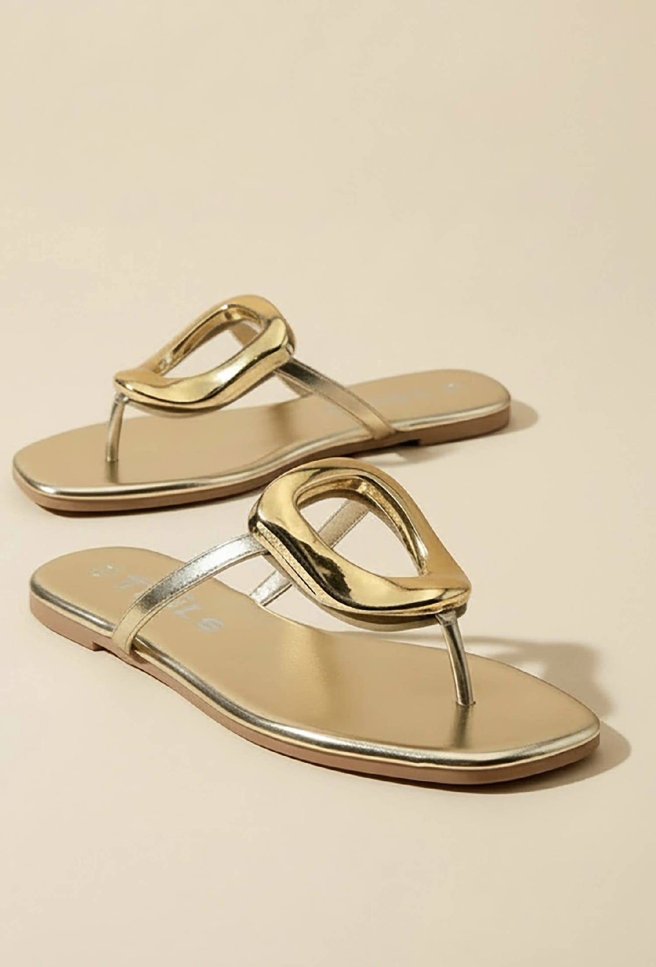 Avery gold metallic flat sandals with sculptural oval hardware toe thong strap