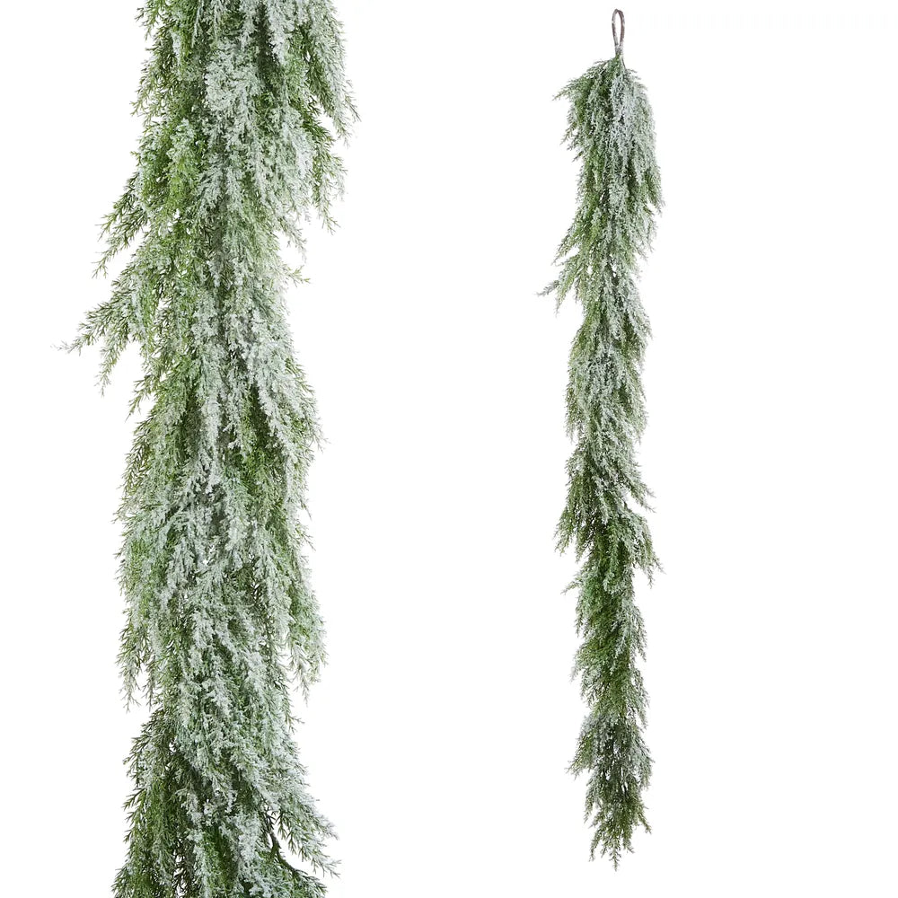 Frosted artificial cedar garland with glitter finish shown hanging vertically