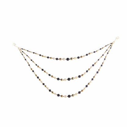 Triple-strand draped beaded garland with black, gold, and pearl white beads on wire hooks