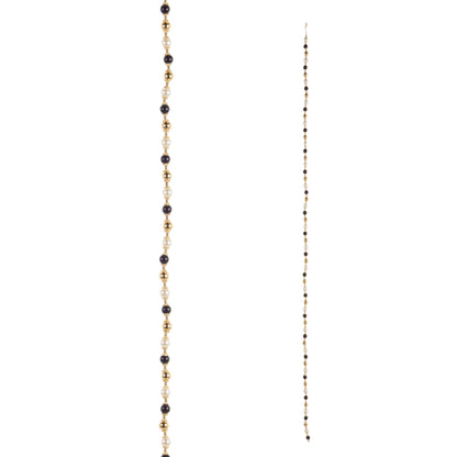 Long beaded garland with alternating black, pearl white, and gold beads, shown full length