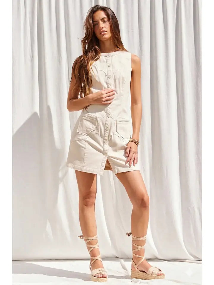 Sleeveless beige button-down mini dress with patch pockets and lace-up espadrille sandals