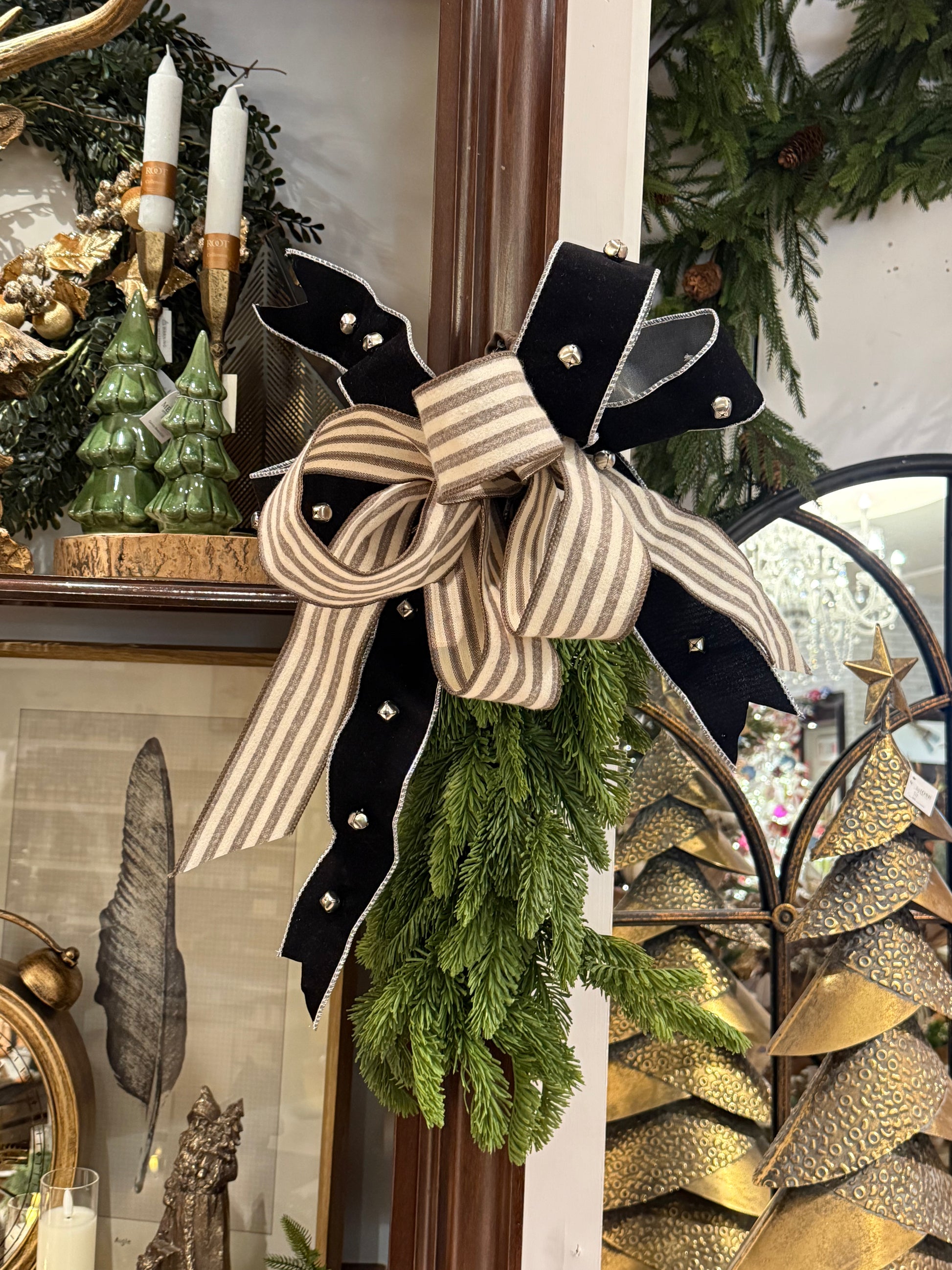 Black velvet and cream striped ribbon bow with silver jingle bells on pine sprig