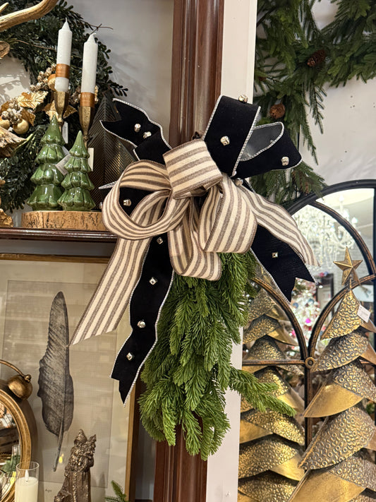 Black velvet and cream striped ribbon bow with silver jingle bells on pine sprig