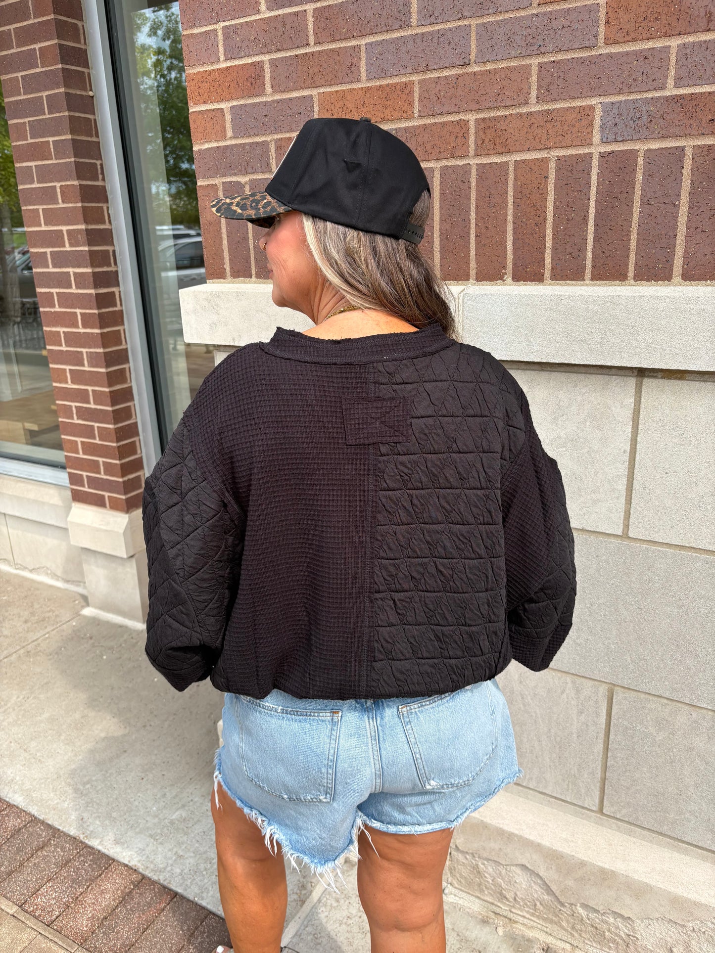 Black mixed quilted and waffle fabric cropped top, back view