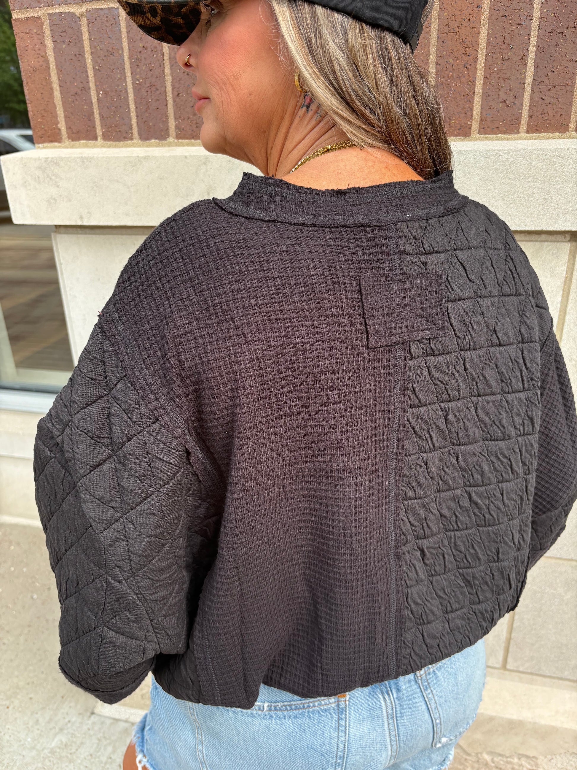Black mixed quilted and waffle fabric cropped top, back view