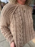 Taupe washed cable-knit crewneck sweater with textured pattern, worn by model