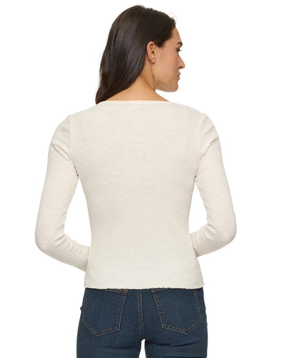Flag and Anthem Arcadia cream ribbed long sleeve top worn with dark jeans, back view