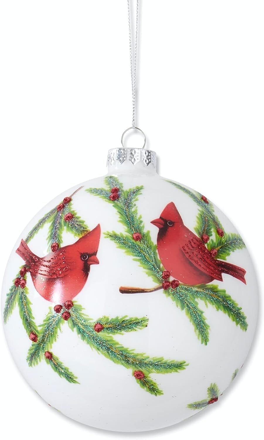 Round white glass Christmas ornament with painted red cardinals perched on glittered pine branches