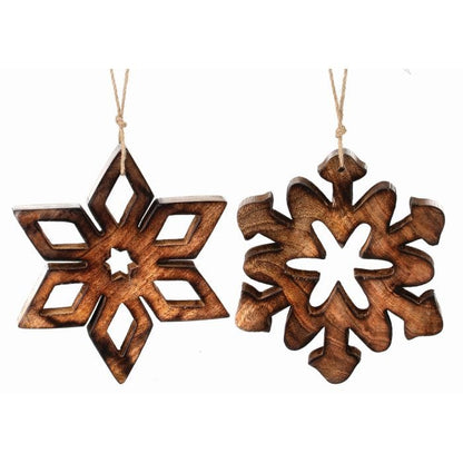Two carved wooden snowflake ornaments with cutout designs hanging from jute twine, front view