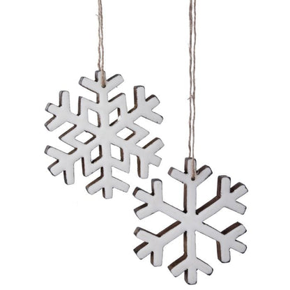 Two white enamel-coated wooden snowflake ornaments hanging from natural twine strings