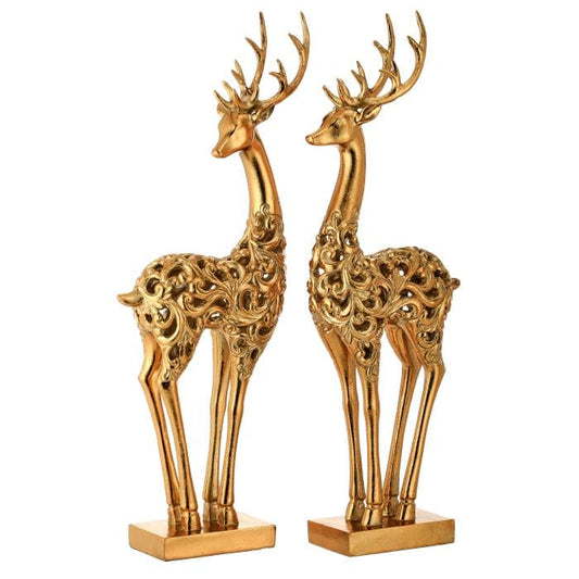 Pair of gold resin deer figurines with ornate scroll filigree bodies and antlers on square bases