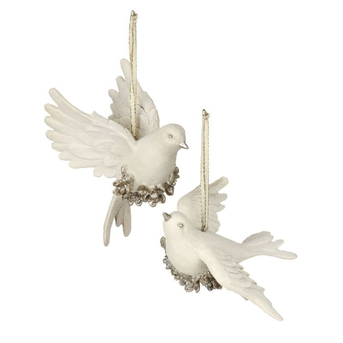 Two white resin dove ornaments with silver floral wreaths and gold ribbon hangers, flying pose