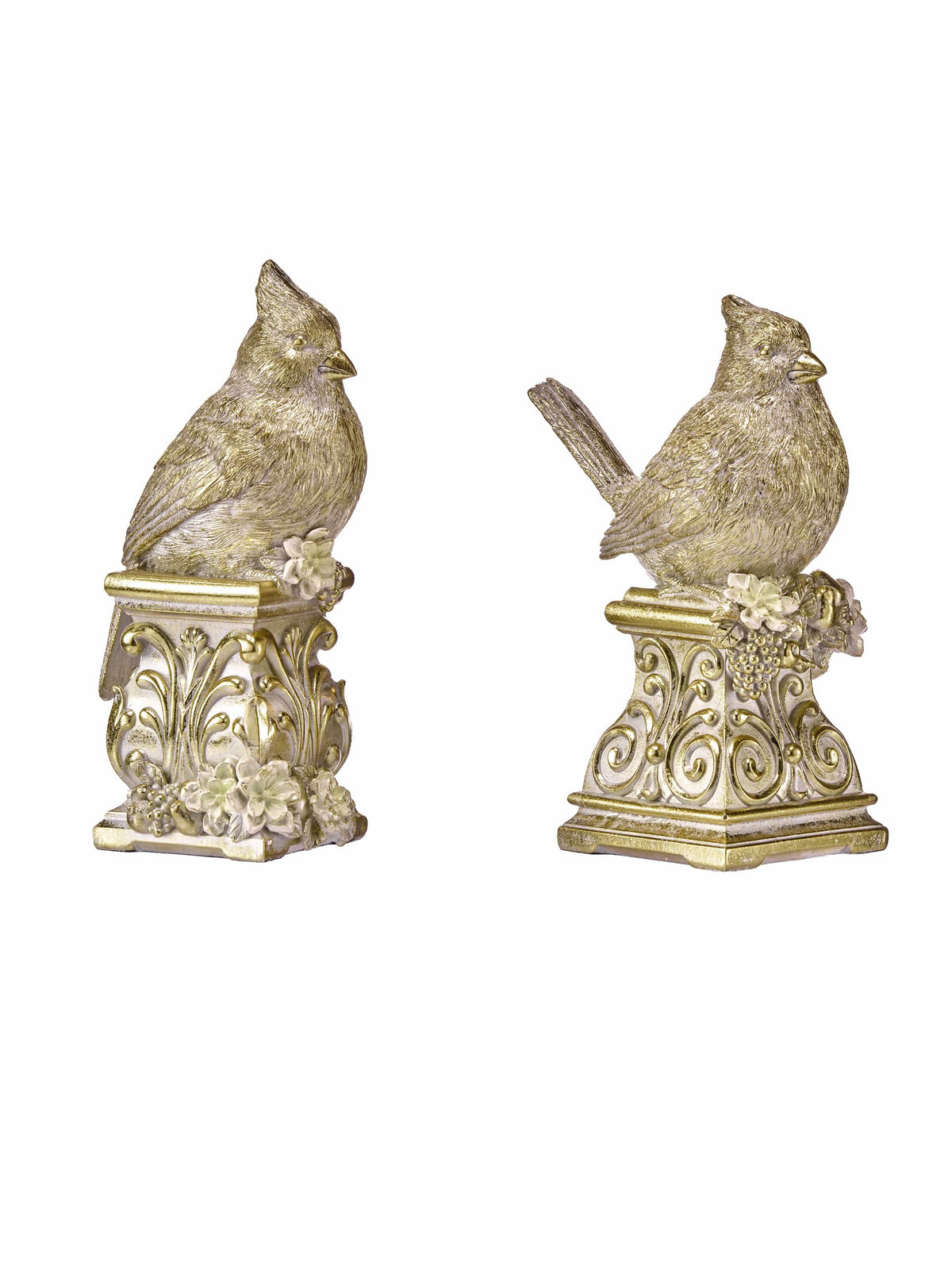Two gold and cream resin cardinal bird figurines perched on ornate decorative pedestals with floral details