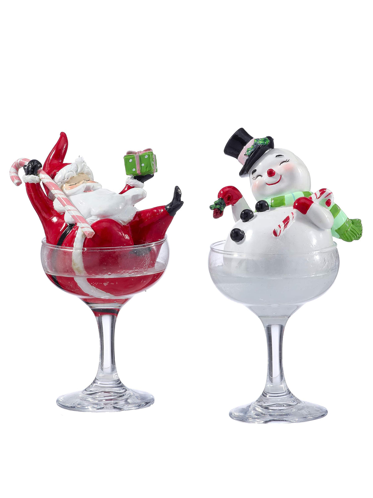 Two festive resin figurines of Santa and a snowman sitting in clear champagne glasses