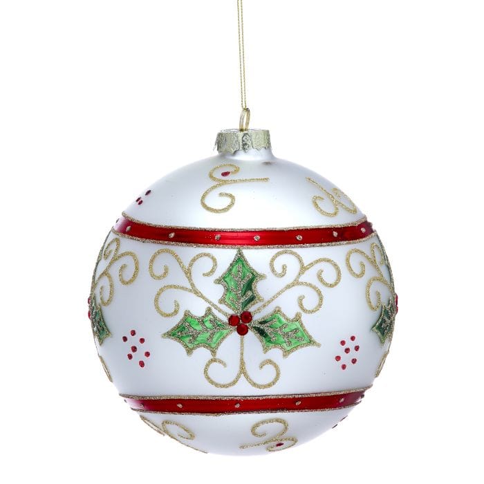 Matte white glass ball ornament with holly leaves, gold scroll designs, and red striped bands