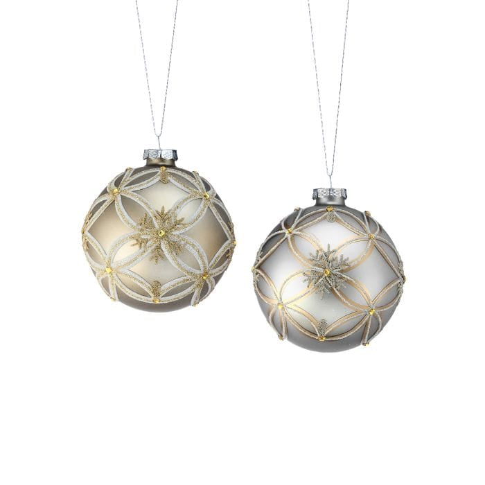 Two matte glass ball ornaments with glitter snowflake and lattice patterns in gold and silver tones