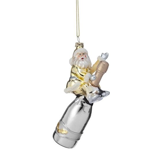 Glass ornament featuring Santa Claus sitting atop a silver champagne bottle, hanging display