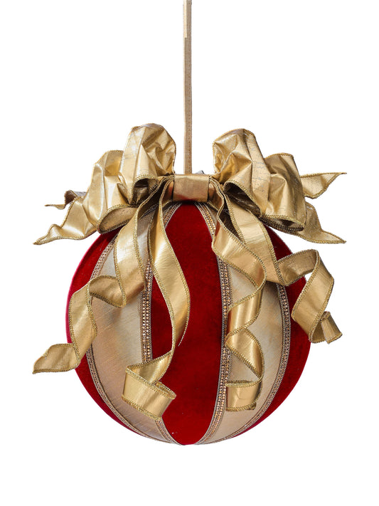 Large red velvet ball ornament with cascading gold ribbon wrap and elaborate gold bow on top