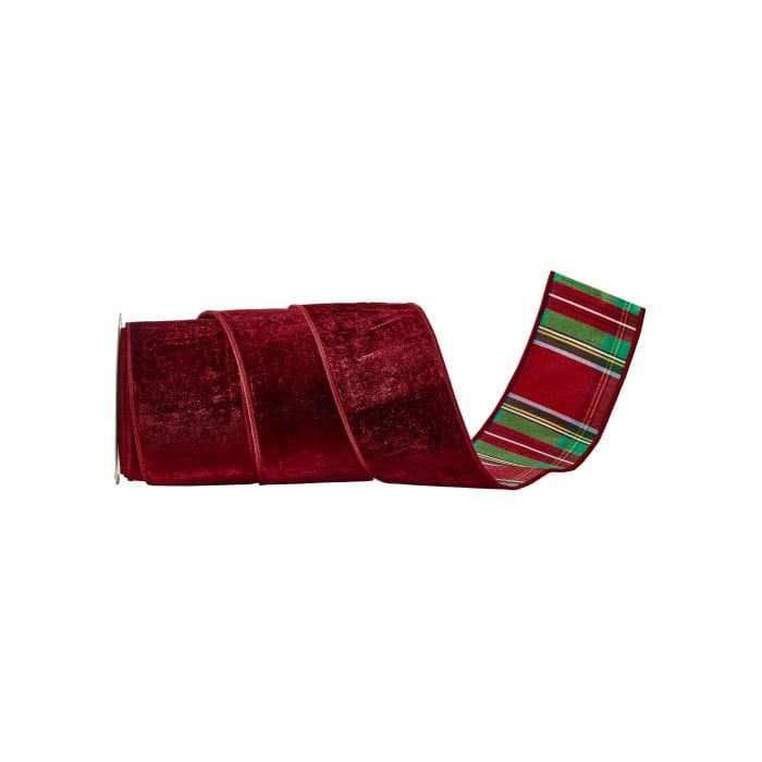 Roll of wide burgundy velvet ribbon with festive red and green plaid backing, partially unrolled