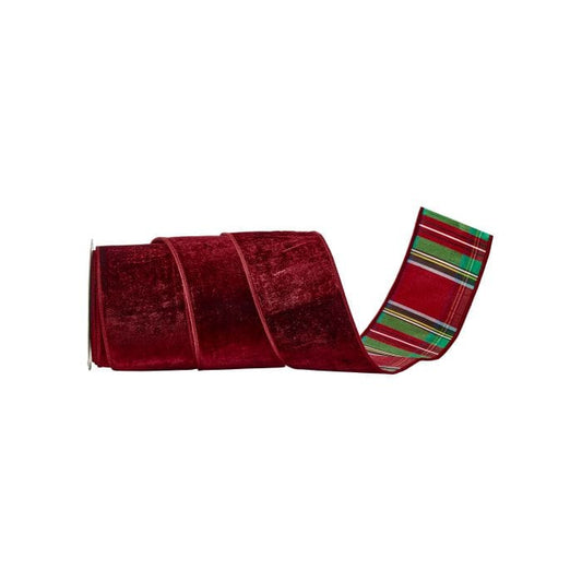 Roll of wide burgundy velvet ribbon with festive red and green plaid backing, partially unrolled