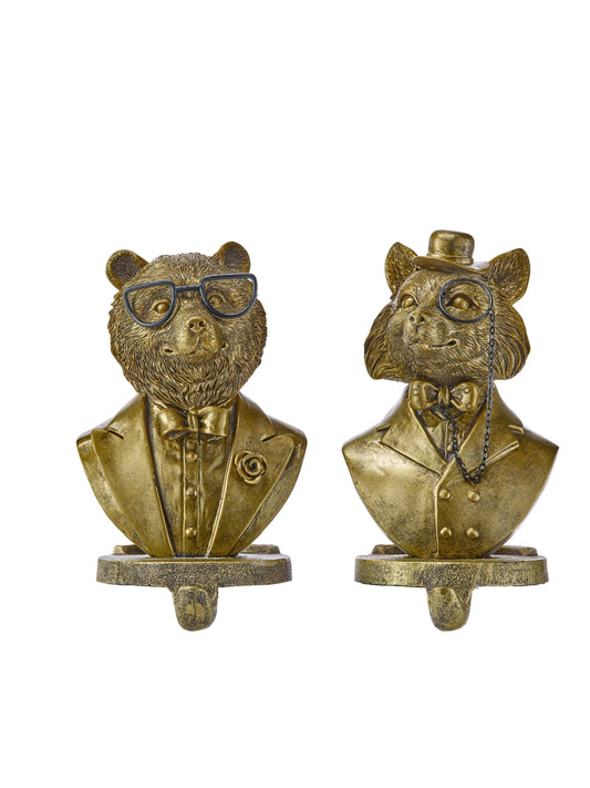 Two gold resin animal bust stocking holders featuring a bear and fox in gentlemen attire