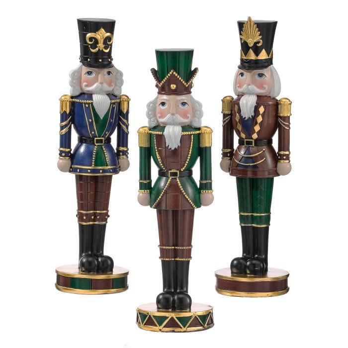 Set of three decorative resin nutcracker figurines in blue, green, and brown with gold trim