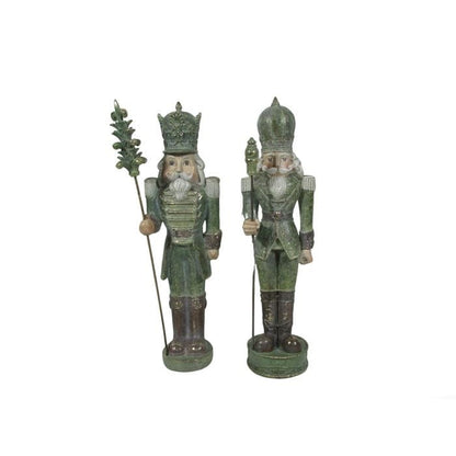 Two antique-style green resin nutcracker figurines with crowns, staffs, and decorative military uniforms