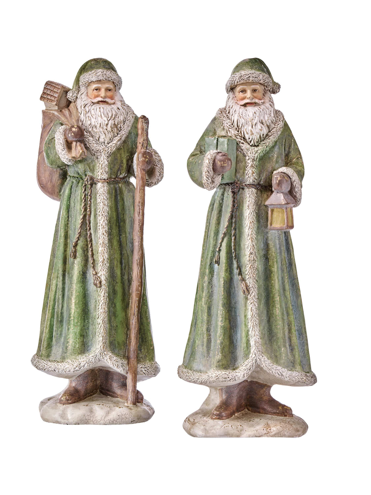 Two antique-style Santa Claus figurines in green robes, one holding a staff and sack, one holding a lantern