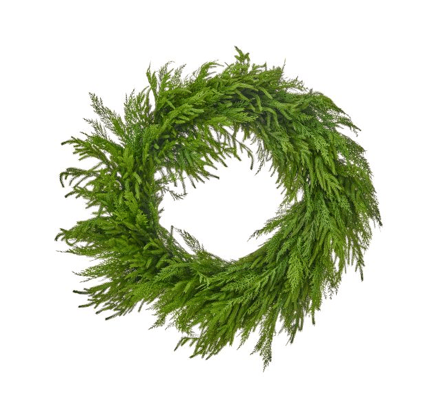 Round holiday wreath made of layered cedar and Norfolk pine branches, top view