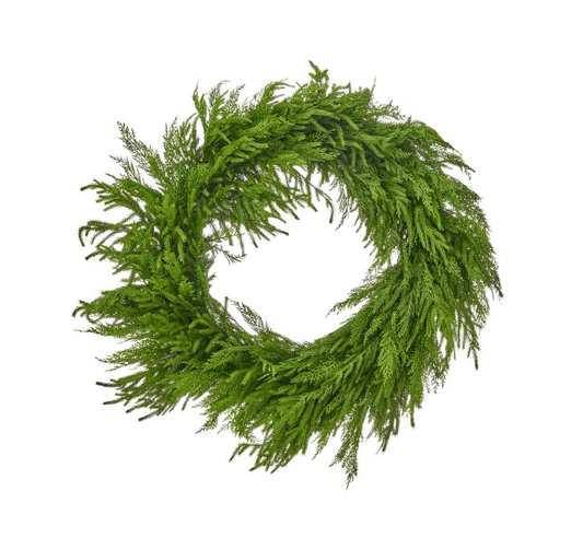 Round holiday wreath made of layered cedar and Norfolk pine branches, top view