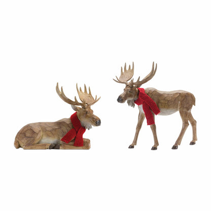 Two resin moose figurines with red knit scarves, one lying down and one standing