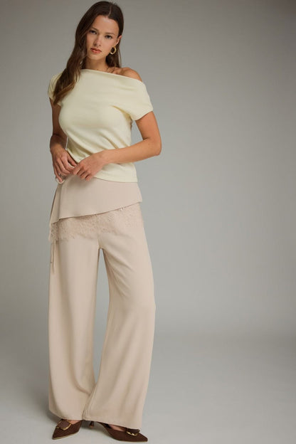 Entro wide-leg cream pants with lace trim waistband detail, worn by model