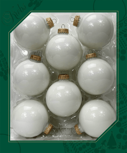 Eight glossy white glass ball ornaments with gold caps arranged in a clear tray packaging