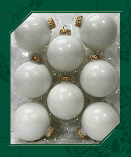 Eight glossy white glass ball ornaments with gold caps arranged in a clear tray packaging