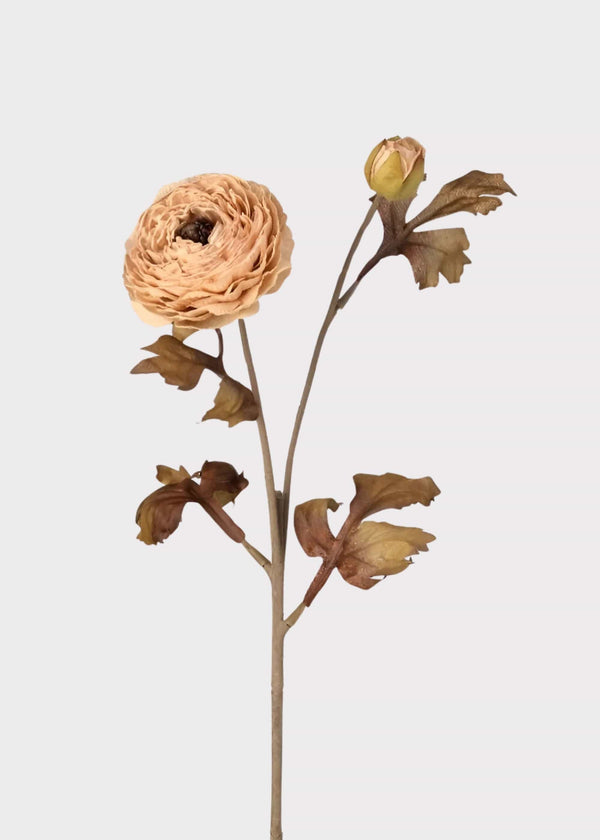 Artificial ranunculus stem with one open bloom, one bud, and dried autumn leaves
