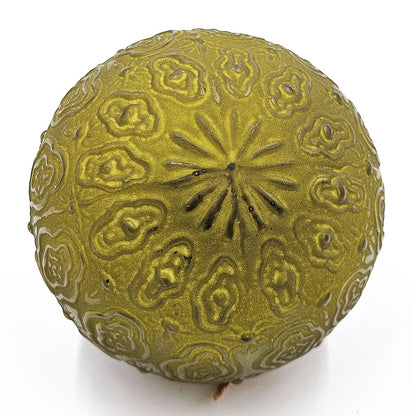 Round ornament ball with intricate embossed floral relief pattern in olive green, top view
