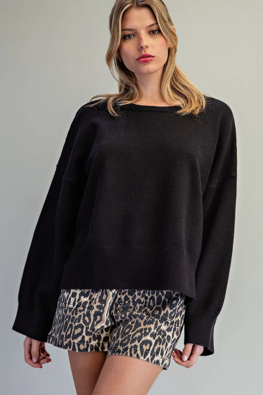 Oversized black crewneck knit sweater with wide sleeves and ribbed cuffs