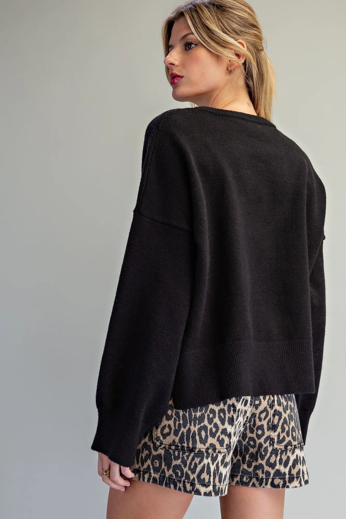 Oversized black crewneck knit sweater with drop shoulders, back view