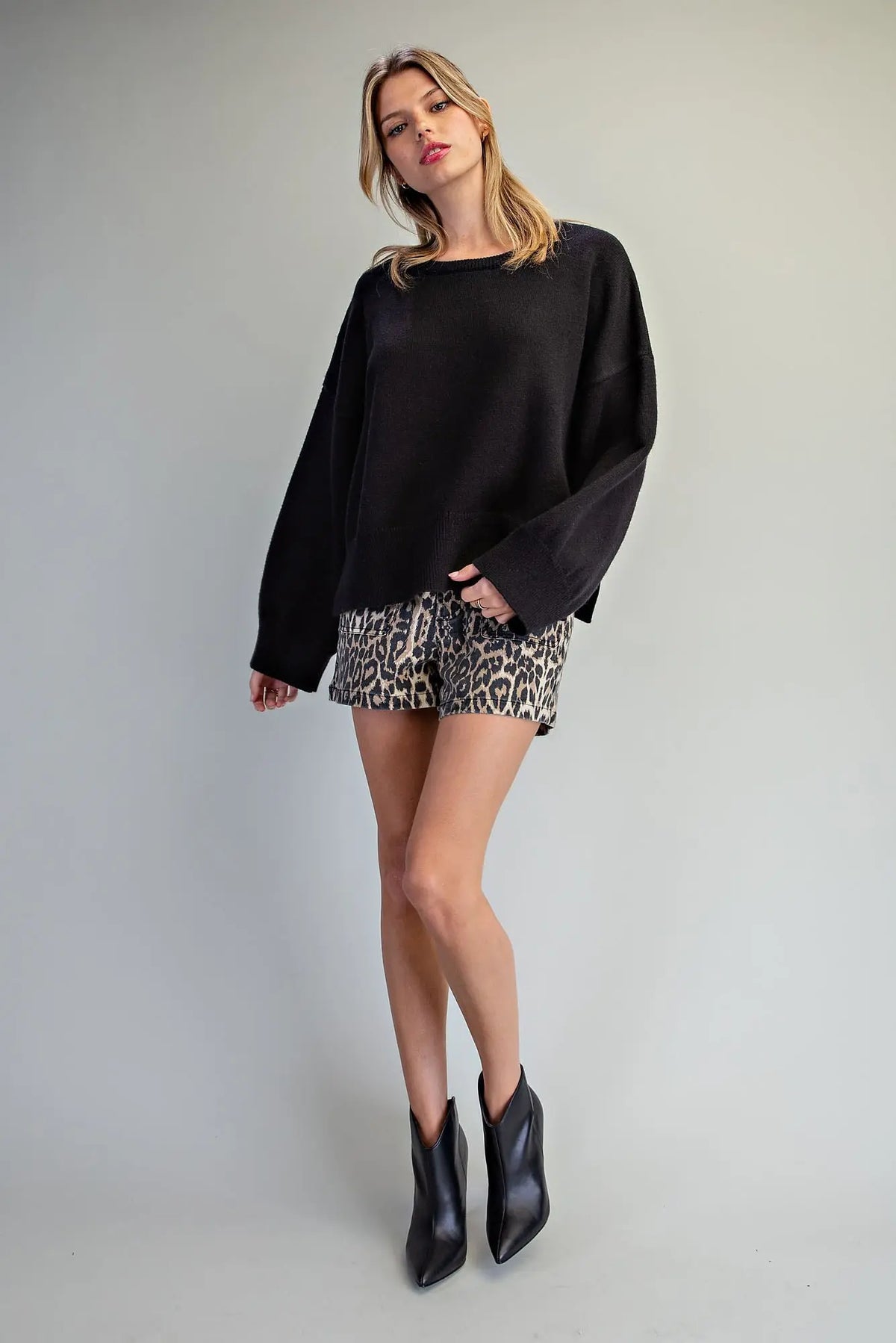 Oversized black crewneck knit sweater with dropped shoulders and wide sleeves