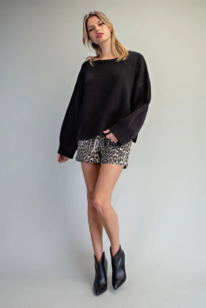 Oversized black crewneck knit sweater with dropped shoulders and wide sleeves