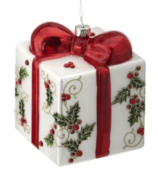 White glass gift box ornament with red bow and holly berry pattern