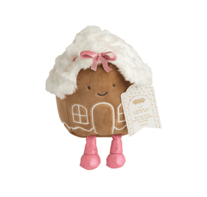 Mudpie gingerbread house plush with white fluffy roof, pink bow, and pink legs
