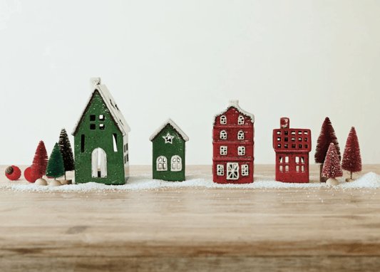 Hand-painted ceramic tealight holder houses in red and green with snow-dusted roofs