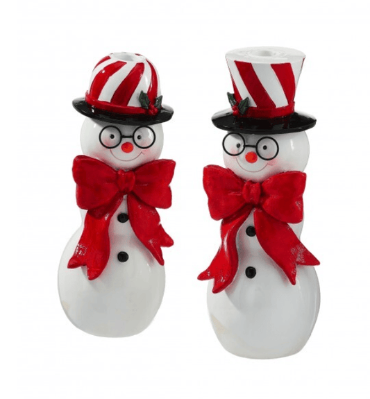 Two white resin snowman taper candle holders with red bows and candy stripe top hats